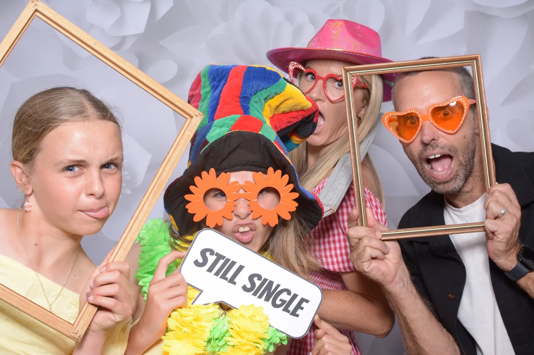 Guests having fun with a frame and party props