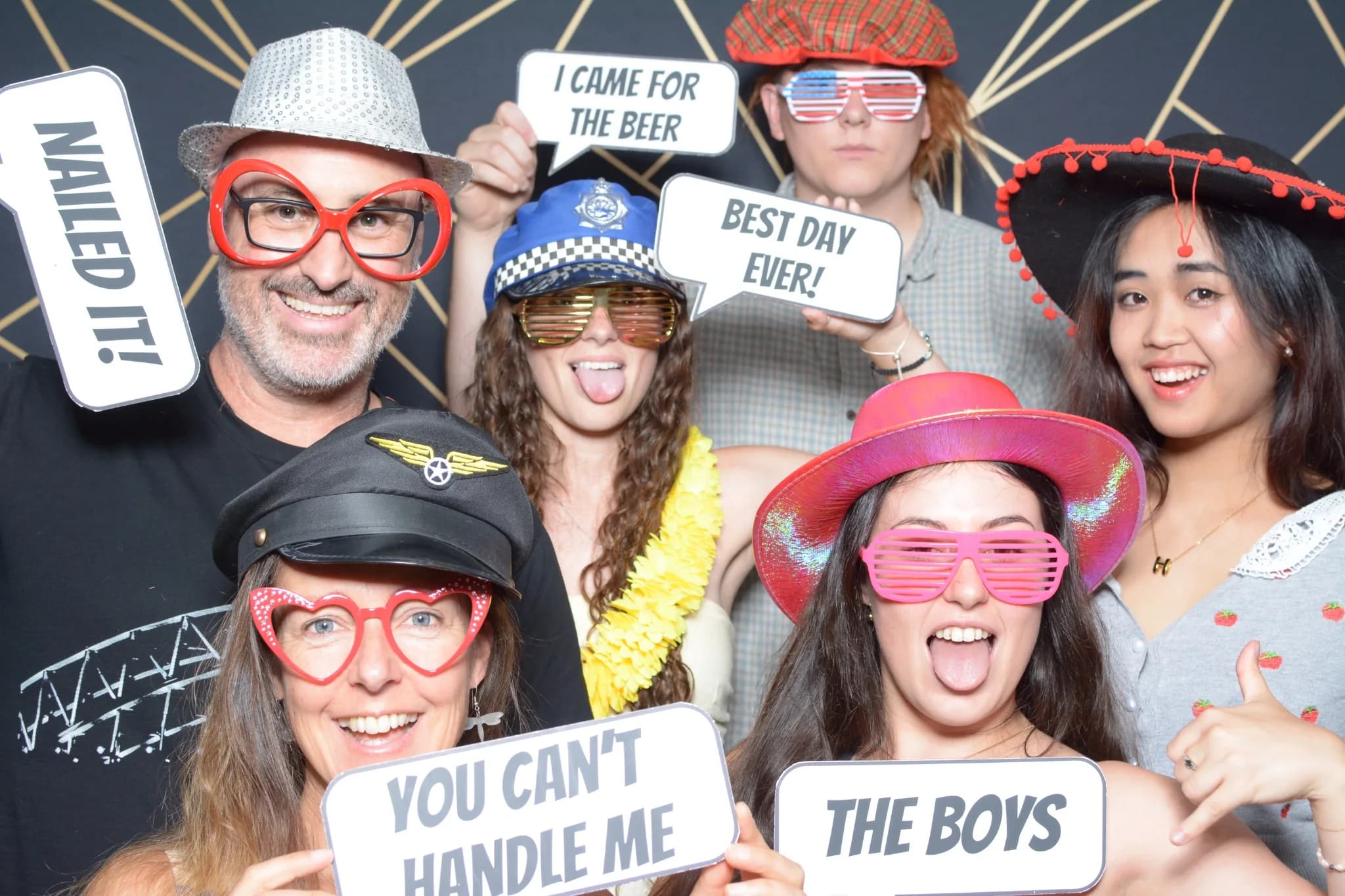 Wedding guests posing together with photo booth props